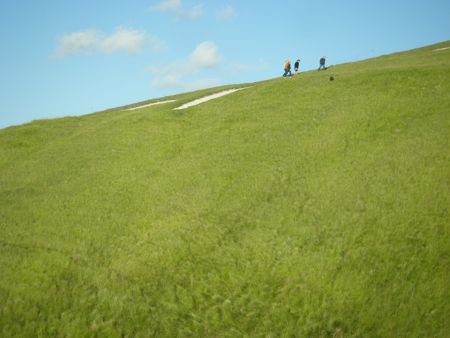 walkers crossing a slope